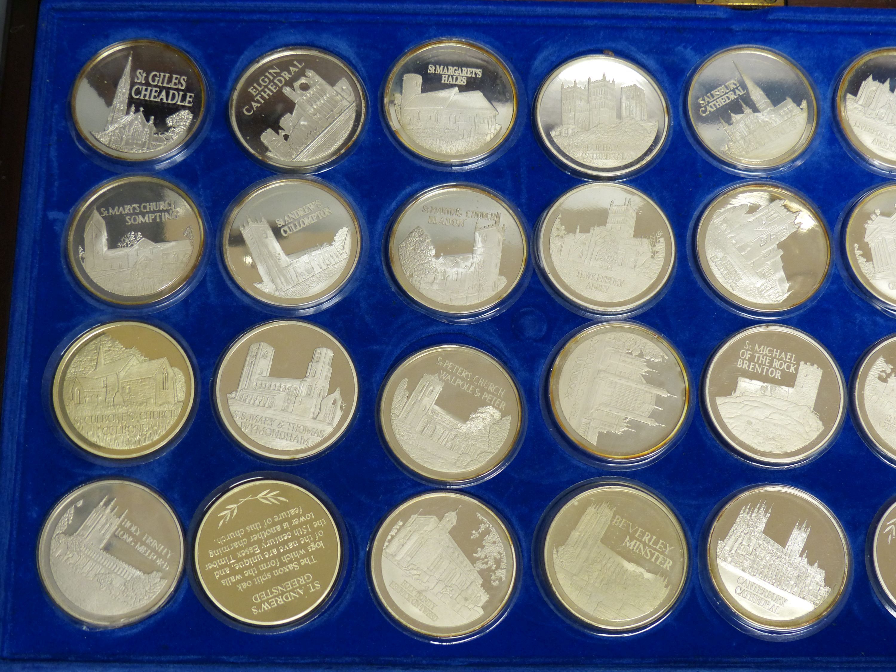 A cased set of 36 silver 'The Beauty of British Churches' medallions,